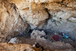 The outer chamber of Lookout Cave, Montana with Larry Loendorf taking notes and Laurie white recording a panel